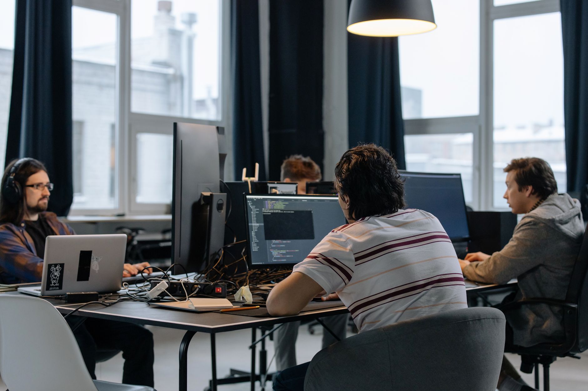 Team of game developers discussing a project in their office
